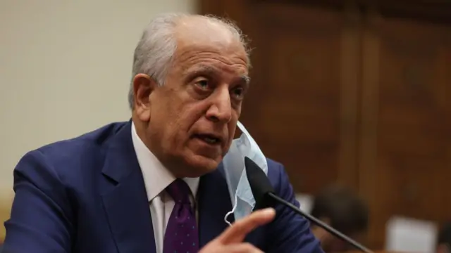 Zalmay Khalilzad speaking into a microphone