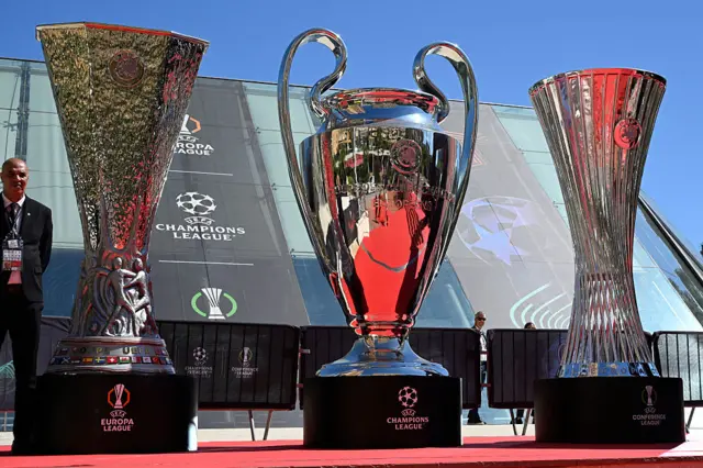Europa League, Champions League and Conference League trophies in a row