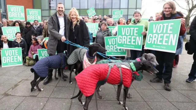 Hannah Spencer with Green Party leader Zack Polanski and her four greyhounds