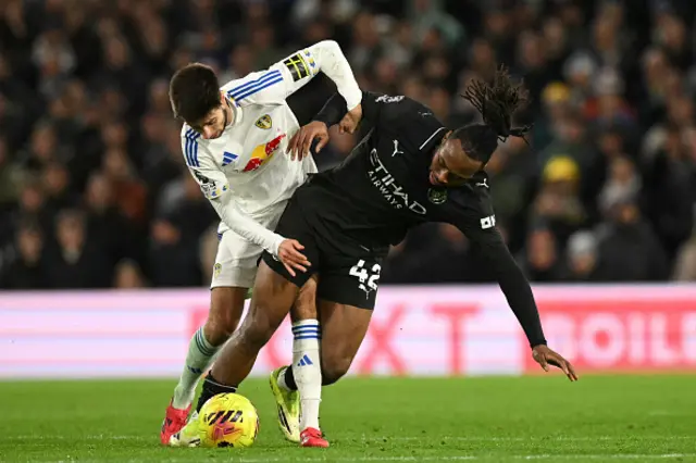 Leeds United's Bulgarian midfielder #44 Ilia Gruev (L) vies with Manchester City's