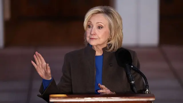Hillary Clinton gestures while speaking to the press outside the Chappaqua Arts Center