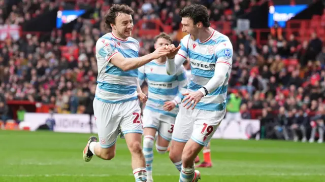 Wrexham goalscorer Ollie Rathbone celebrates with Kieffer Moore