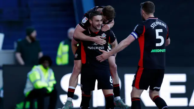 Taylor Harwood-Bellis is joined in celebration by his Southampton team-mates