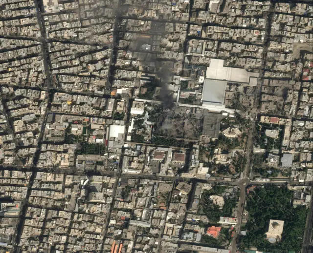 Satellite image of Tehran showing a plume of black smoke billowing into the air from Leadership House