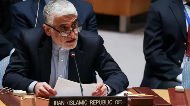 Iran's Ambassador to the United Nations, Amir-Saeid Iravani holds a paper he is reading from in front of a microphone at a United Nations Security Council meeting after the US and Israel launched strikes on Iran.