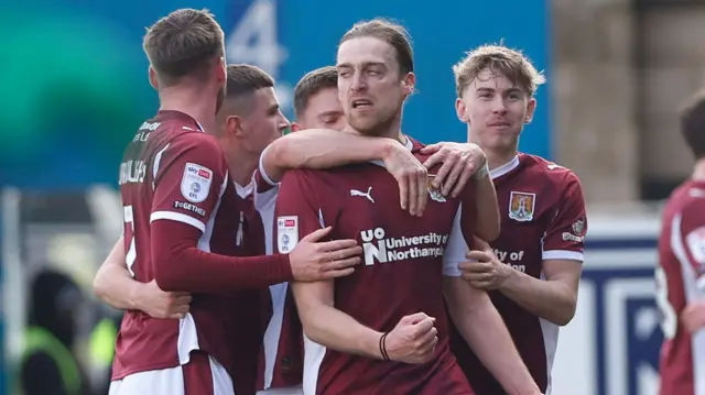 Tom Eaves celebrates his goal with Northampton team mates