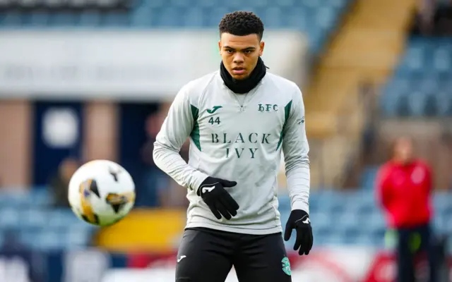 Dane Scarlett warming up for Hibs at Dens Park