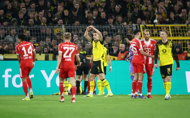 Nico Schlotterbeck of Borussia Dortmund gestures for a substitution after teammate Emre Can goes down injured