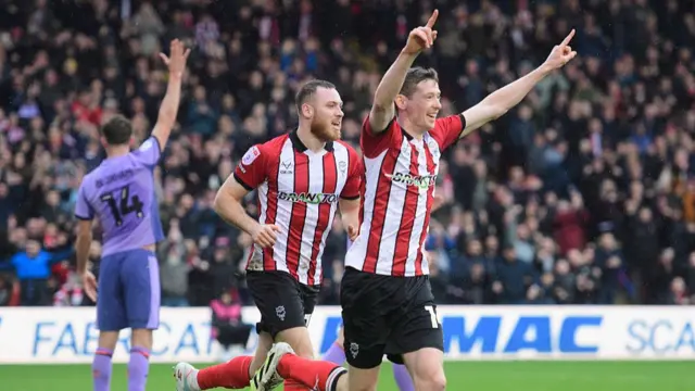 Conor McGrandles of Lincoln City celebrates scoring the opening goal for Lincoln against Blackpool