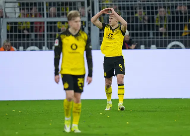 Nico Schlotterbeck of Borussia Dortmund acknowledges the fans as he celebrates