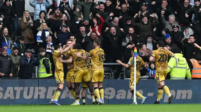 Blackburn players celebrate in front of the travelling supporters