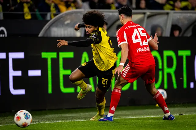 Karim Adeyemi of Borussia Dortmund is challenged by Aleksandar Pavlovic
