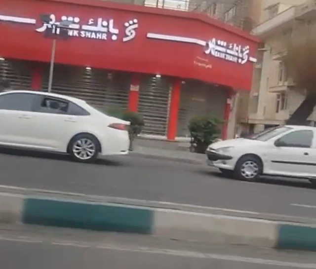 This image from inside Tehran was sent to the BBC from the Iranian capital - shows two white cars