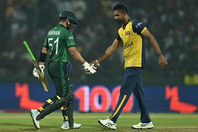 Sri Lanka's captain Dasun Shanaka (R) congratulates Pakistan's Sahibzada Farhan after scoring his century (100 runs) during the 2026 ICC Men's T20 Cricket World Cup Super Eights match between Sri Lanka and Pakistan at Pallekele International Cricket Stadium