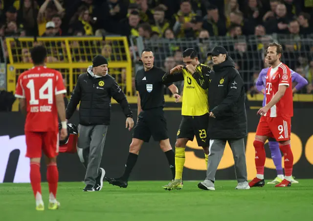 Emre Can of Borussia Dortmund is helped off the pitch after going down injured