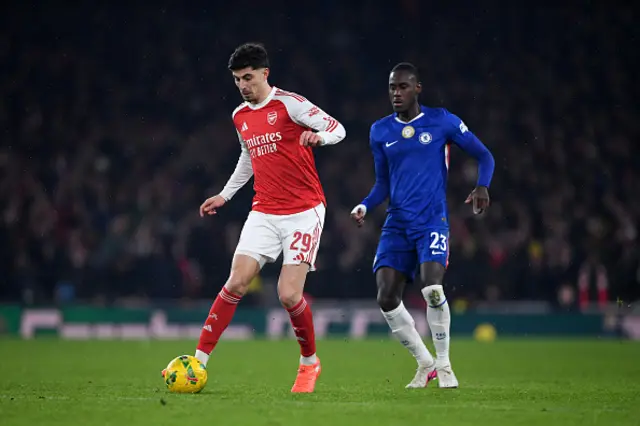 Kai Havertz of Arsenal passes the ball whilst under pressure from Trevoh Chalobah