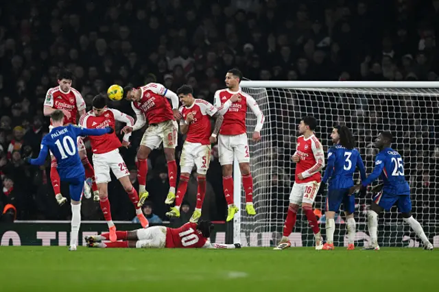 Cole Palmer of Chelsea takes a free kick as Gabriel of Arsenal and teammates defend