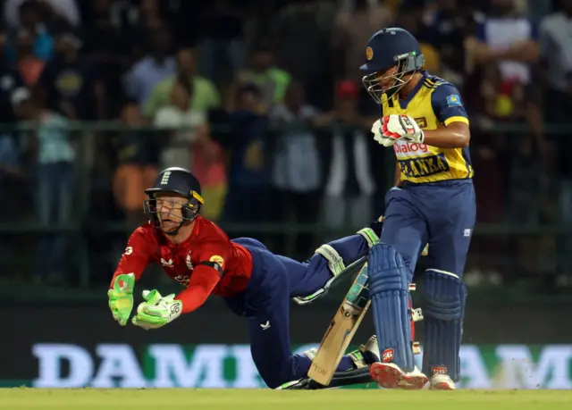 England's Jos Buttler takes a catch to dismiss Sri Lanka's Dunith Wellalage off the bowling of England's Jacob Bethell