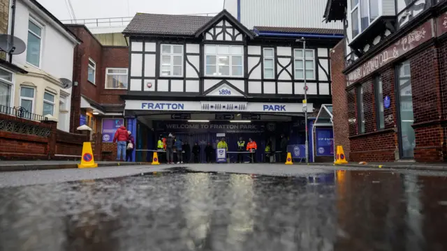 Rain puddles on the ground outside Fratton Park