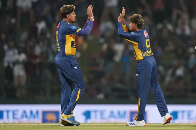 Dunith Wellalage (R) of Sri Lanka celebrates the wicket of Tom Banton