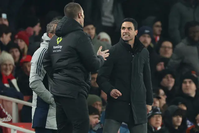 Mikel Arteta (R) clashes with the fourth official Thomas Bramall