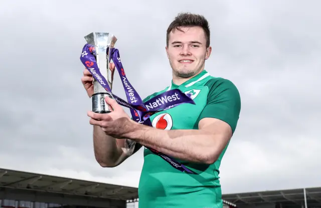 Jacob Stockdale in an Ireland jersey with his Six Nations player of the tournament trophy