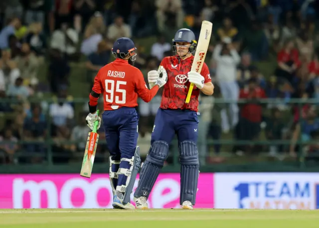 England's Sam Curran celebrates after reaching his half century with England's Adil Rashid