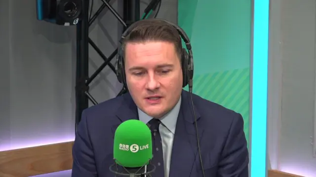 Wes Streeting speaks into a microphone in the 5 Live studio