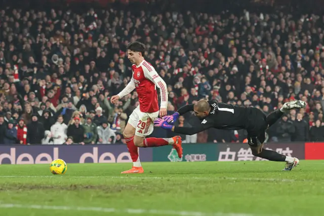 Kai Havertz of Arsenal scores their first goal past Chelsea goalkeeper Robert Sanchez