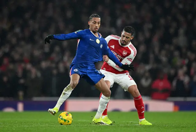 Joao Pedro of Chelsea is challenged by William Saliba