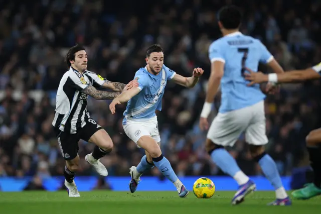 Sandro Tonali of Newcastle (L) in action against Nico Gonzalez of Manchester City (C)