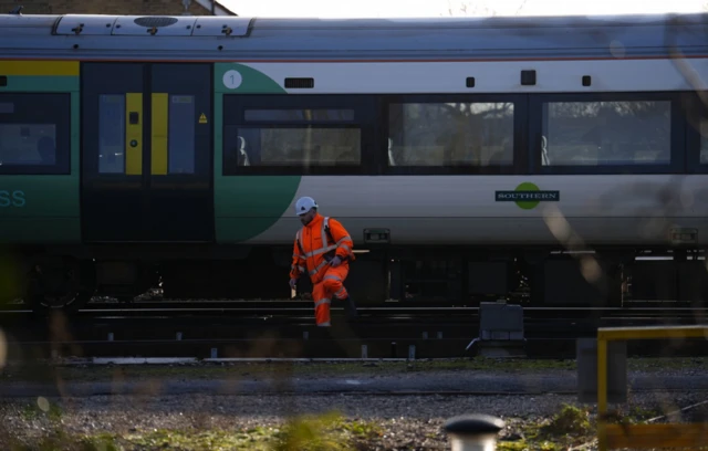 Engineers work on a derailed train at Selhurst train depot south-east London
