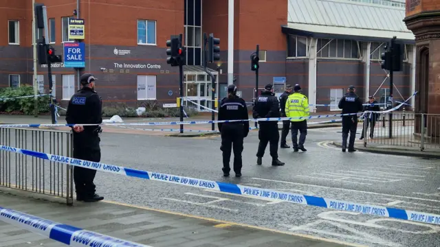 Police officers inside a police cordon in Leicester