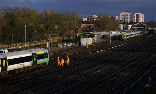 Engineers work on a derailed train at Selhurst train depot south-east London