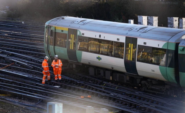 Engineers work on a derailed train at Selhurst train depot south-east London