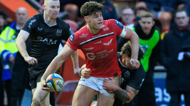 Eddie James carries the ball for Scarlets