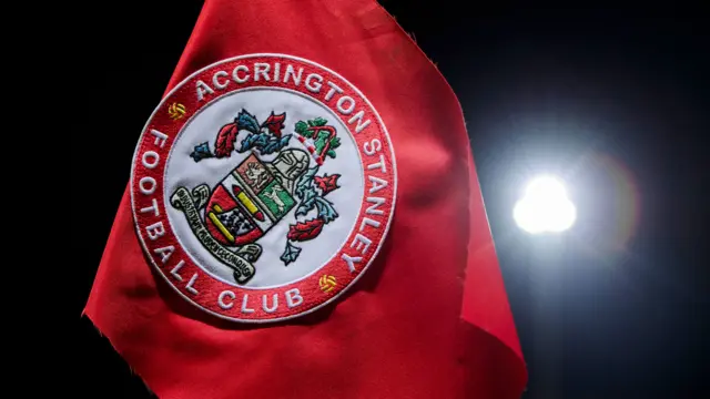 Close-up of Accrington Stanley corner flag with floodlight in background