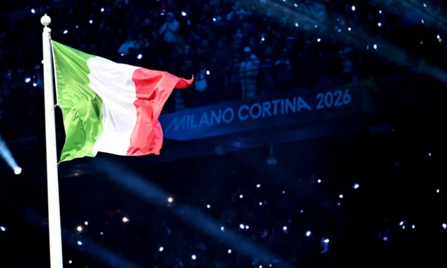 The Italian flag flies after being raised during the Opening Ceremony