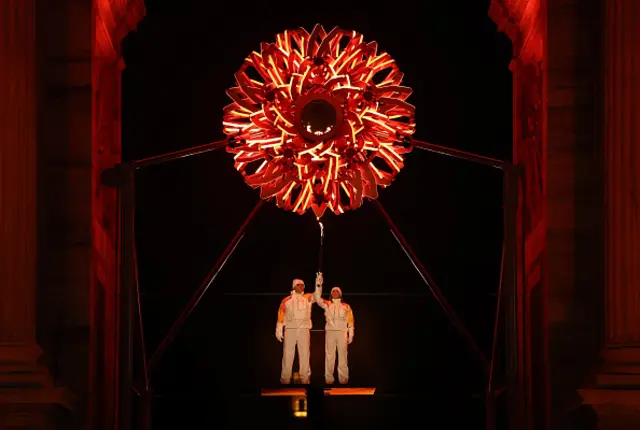 Torchbearers Deborah Compagnoni and Alberto Tomba lights the Olympic cauldron