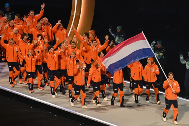 Netherlands' flag bearer Jens Van T Wout parades with other athletes