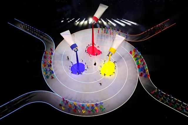 Giant paint tubes are seen as performers dance