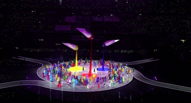 Three giant paint tubes in a performance