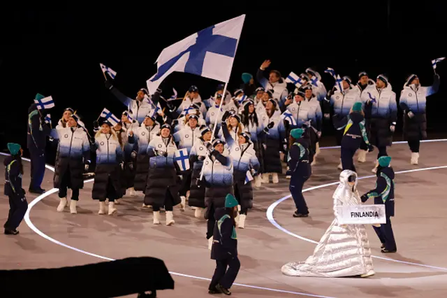 Flagbearer Mikko Lehtonen of Team Finland leads the team