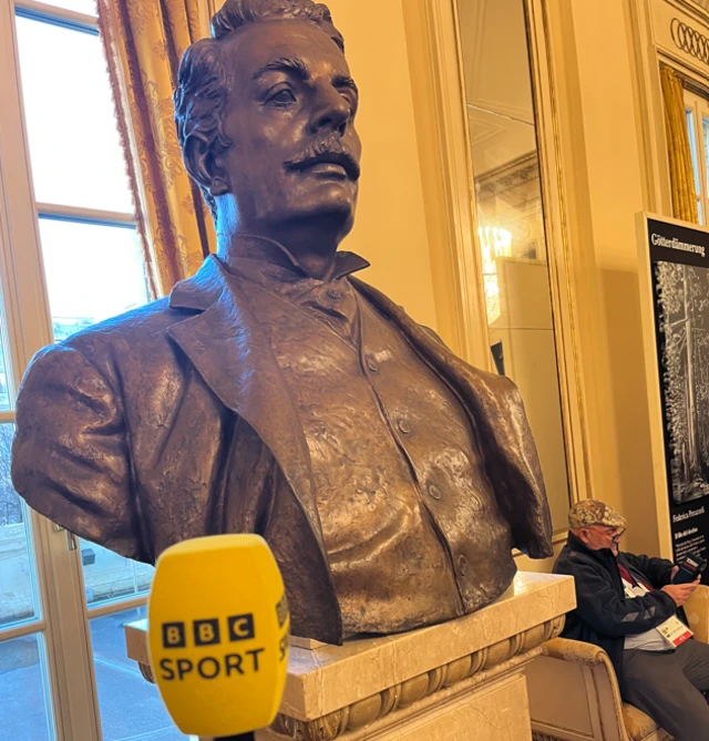 Giacomo Puccini statue with a BBC Sport microphone