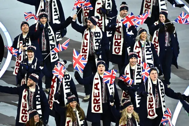 The athletes of the United Kingdom parade during the opening ceremony of the Milano Cortina 2026 Winter Olympics at Stadio San Siro on February 06, 2026 in Milan, Italy