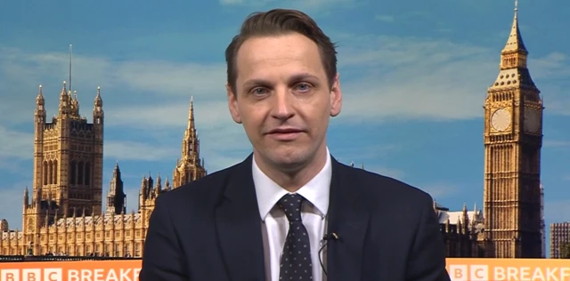 Government minister Mike Tapp sits against the backdrop of Parliament and Big Ben while talking to BBC Breakfast
