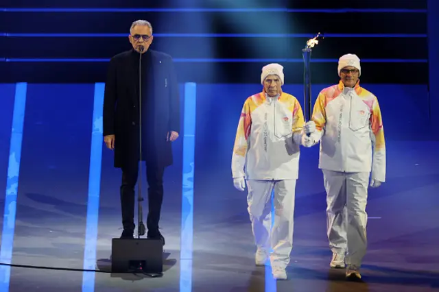 Andrea Boccelli performs as the Olympic flame is carried in the stadium