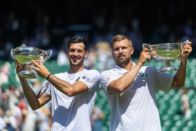 Julian Cash and Lloyd Glasspool of Great Britain celebrate with the winner's trophies