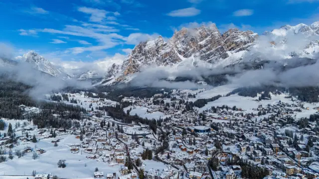 A distant landscape view of Cortina in snowy conditions