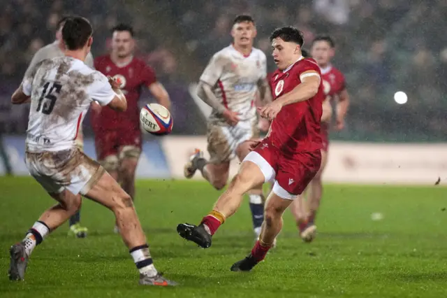 A Wales player kicks the ball forward